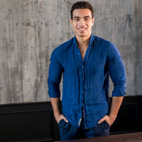 retrato sonriente de un hombre joven con sus manos en el bolsillo